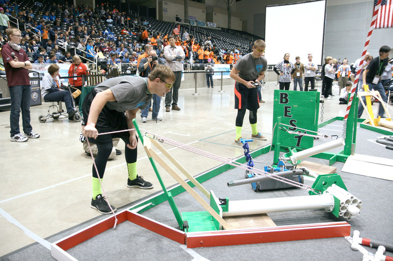 Photo of a student competing in the robotics event