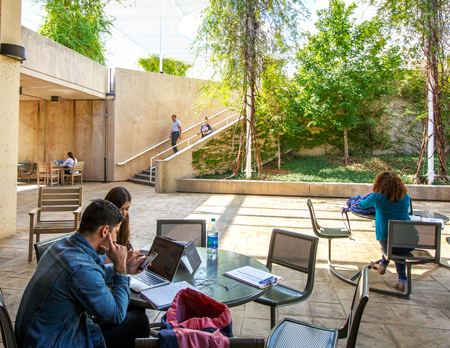 Students sitting in the McDermott Library courtyard