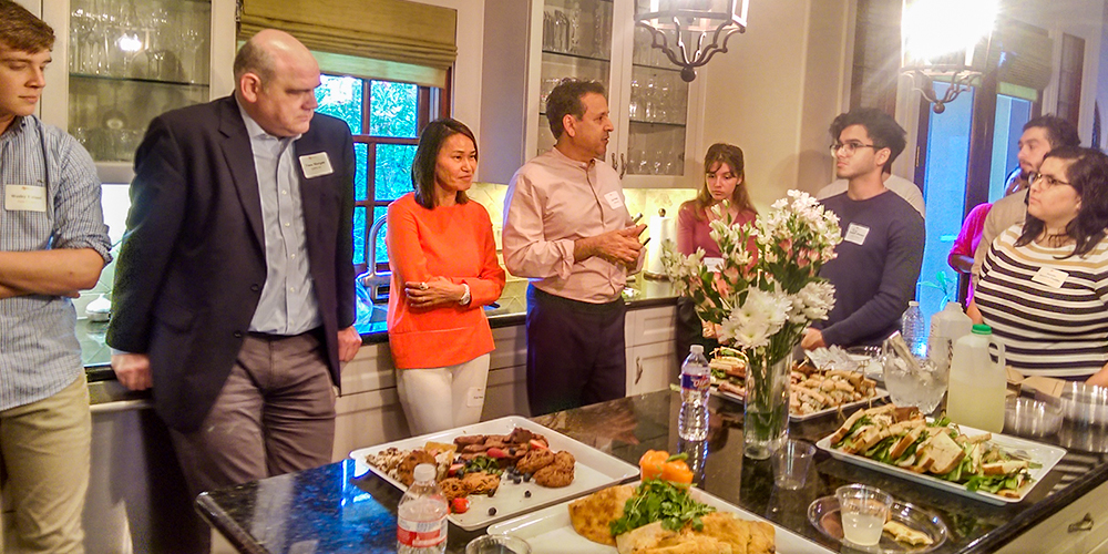 Hosts Kal Malik BS’86 (fourth from left) and his wife, Feli Wong (third from left), welcome the incoming students and their families to the Houston send-off.