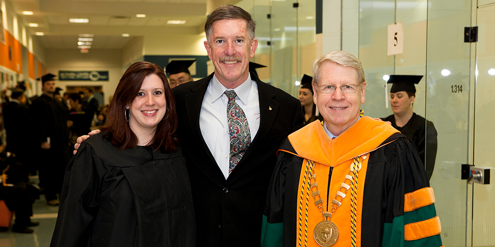 The Reillys are pictured with former UT Dallas President David Daniel.