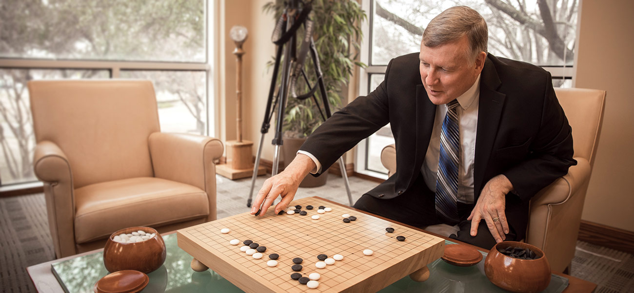 President Benson plays the board game go in his office