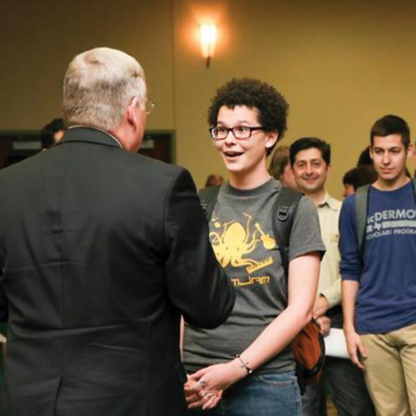 A student speaks with President Benson