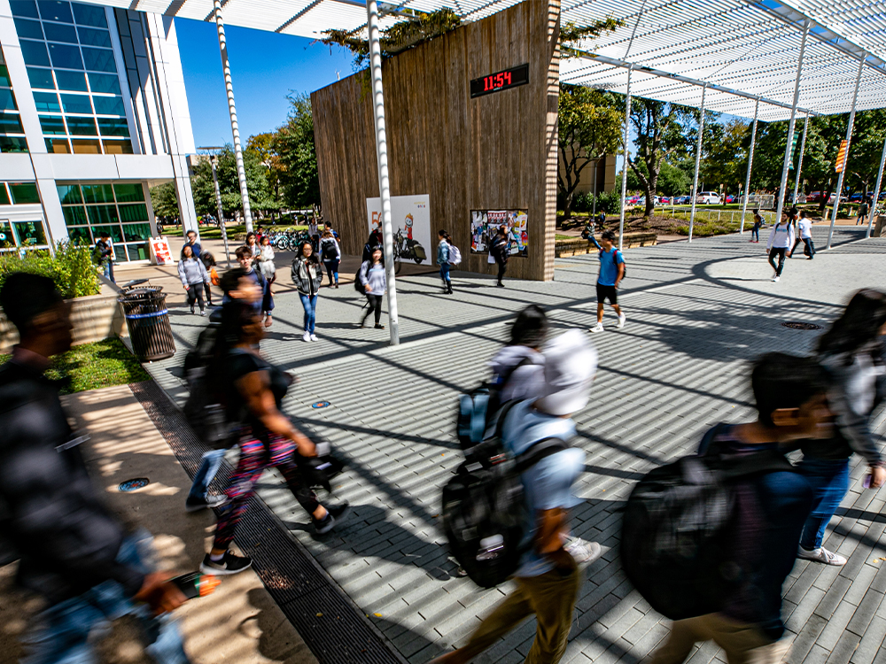 Students walk underneath the Trellis as they head toward their classrooms.