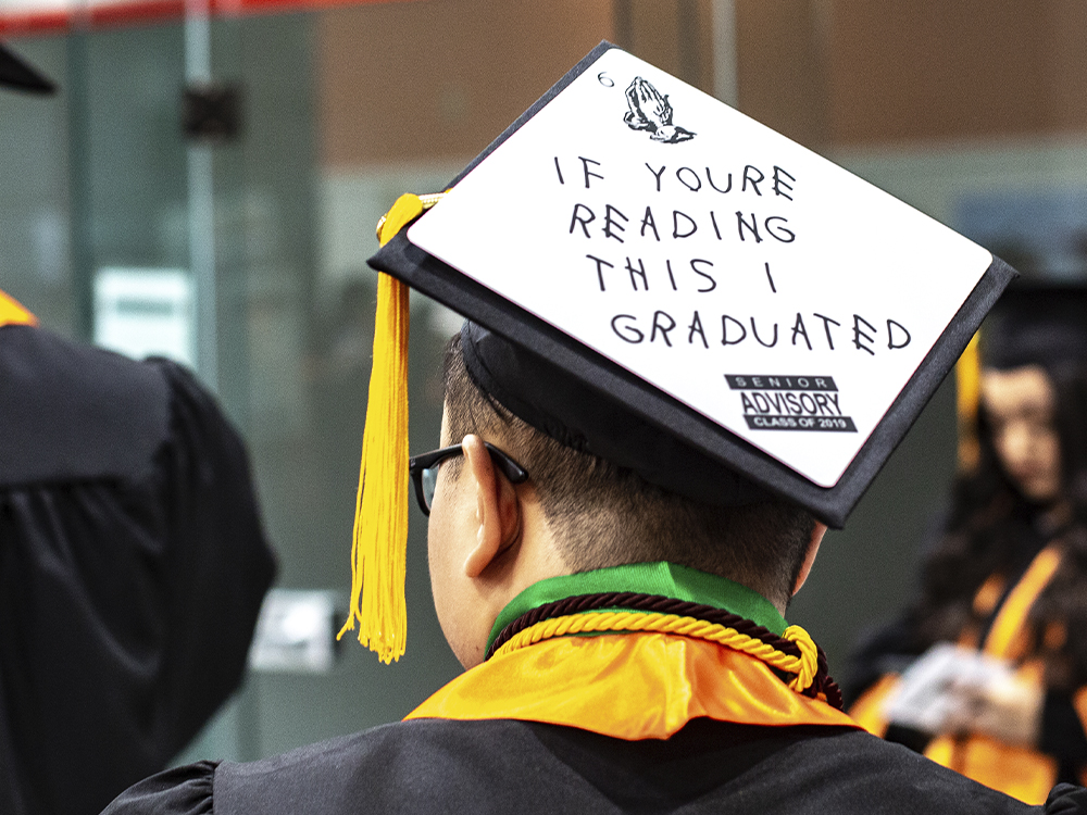 Man wearing cap that says If you're reading this I graduated