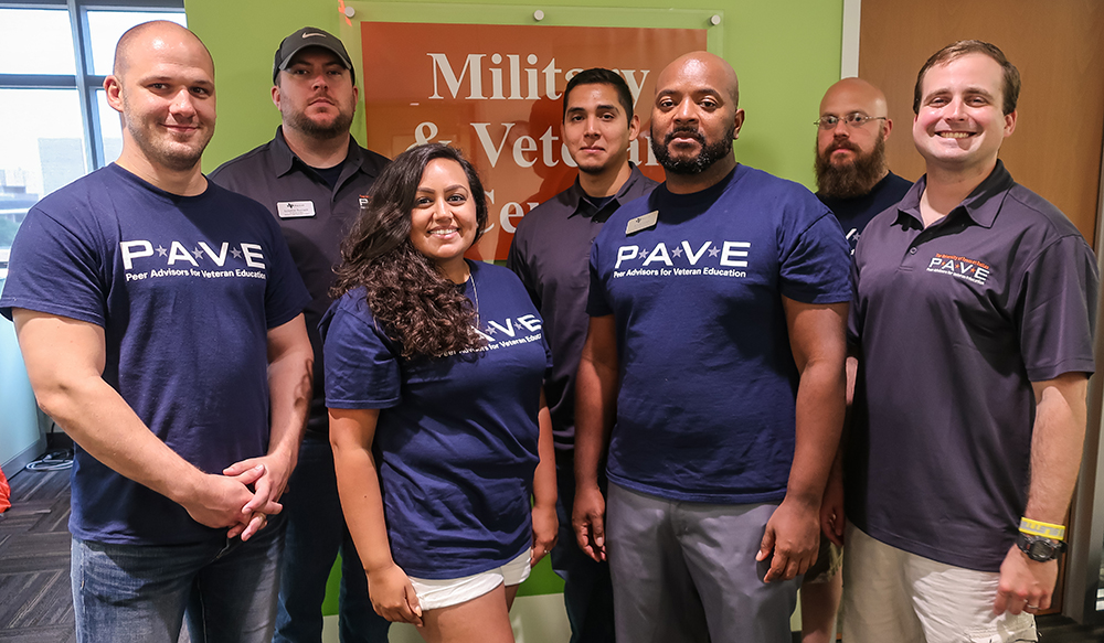 : Marcus Ayala, a PAVE advisor (far right), and BJard Jones, a PAVE team leader (center right), join a group of fellow PAVE advisors at a welcome lunch last year.
