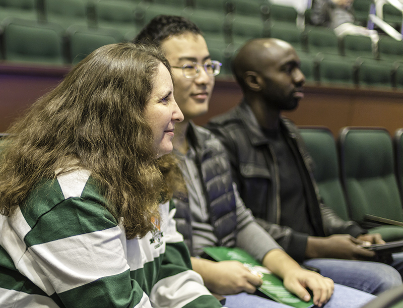 Chen Pan, and Chisom Akagha are apart of the chess class and with their instructor, Alexey Root, watch the Transatlantic Cup. 