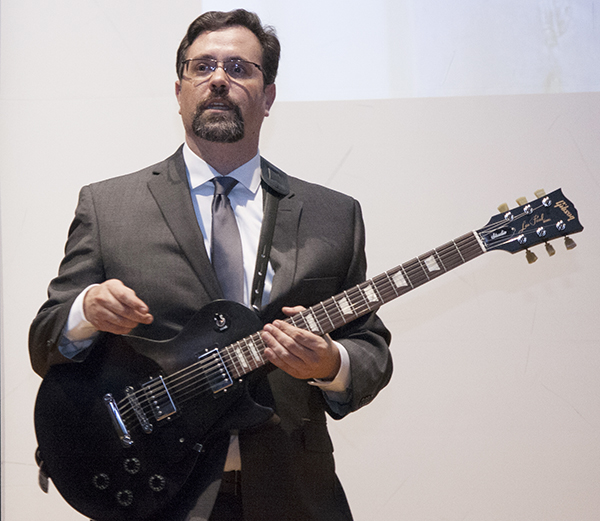Dr. Russell Stoneback performs on his prototype of a light guitar that translates resonances in light waves into sound.