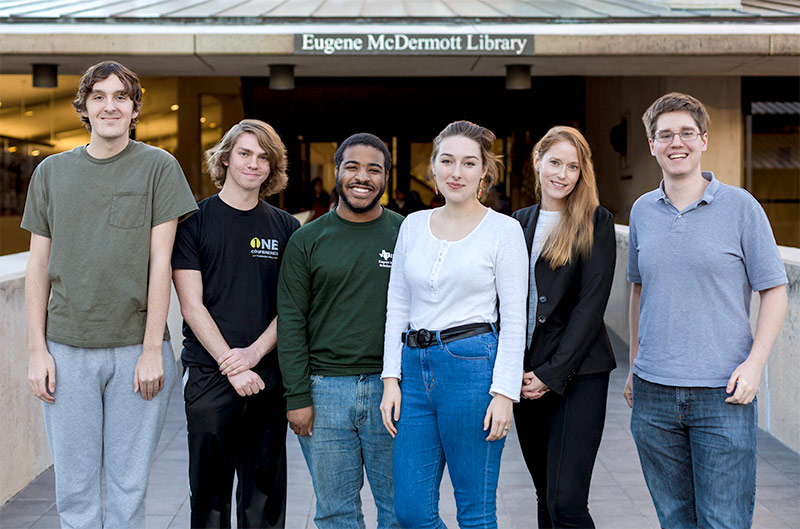 six members of quiz bowl team pose in front of the library