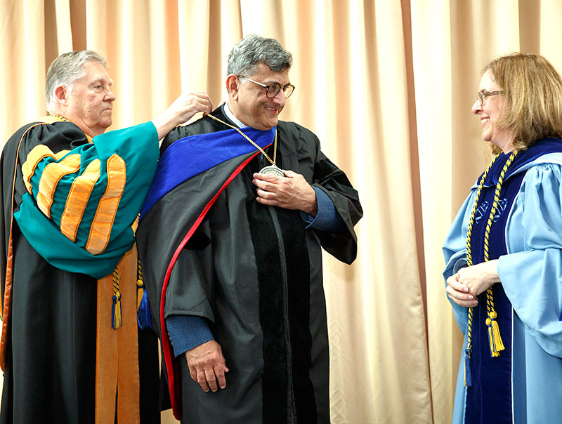 Dr. Wildenthal behind Dr. Vikram Nanda