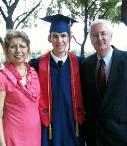 Michael Noble with parents at graduation.