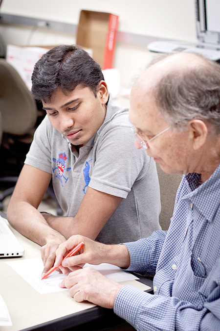 Mahesh Babu Rajasekar and Alan Anderson work in Dr. Lawrence Chungs requirements engineering lab.