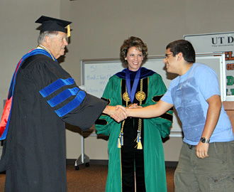 Provost Wildenthal, Dr. Boots and a student chosen to be a member of Phi Kappa Phi