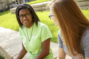 Students talk outside of a residence hall