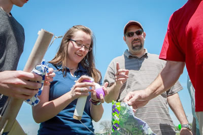 Mikaela McMurtry discovers that the raw egg payload on her team’s rocket has returned intact. Her team's rocket won the contest for going 383 feet and protecting the egg cargo.